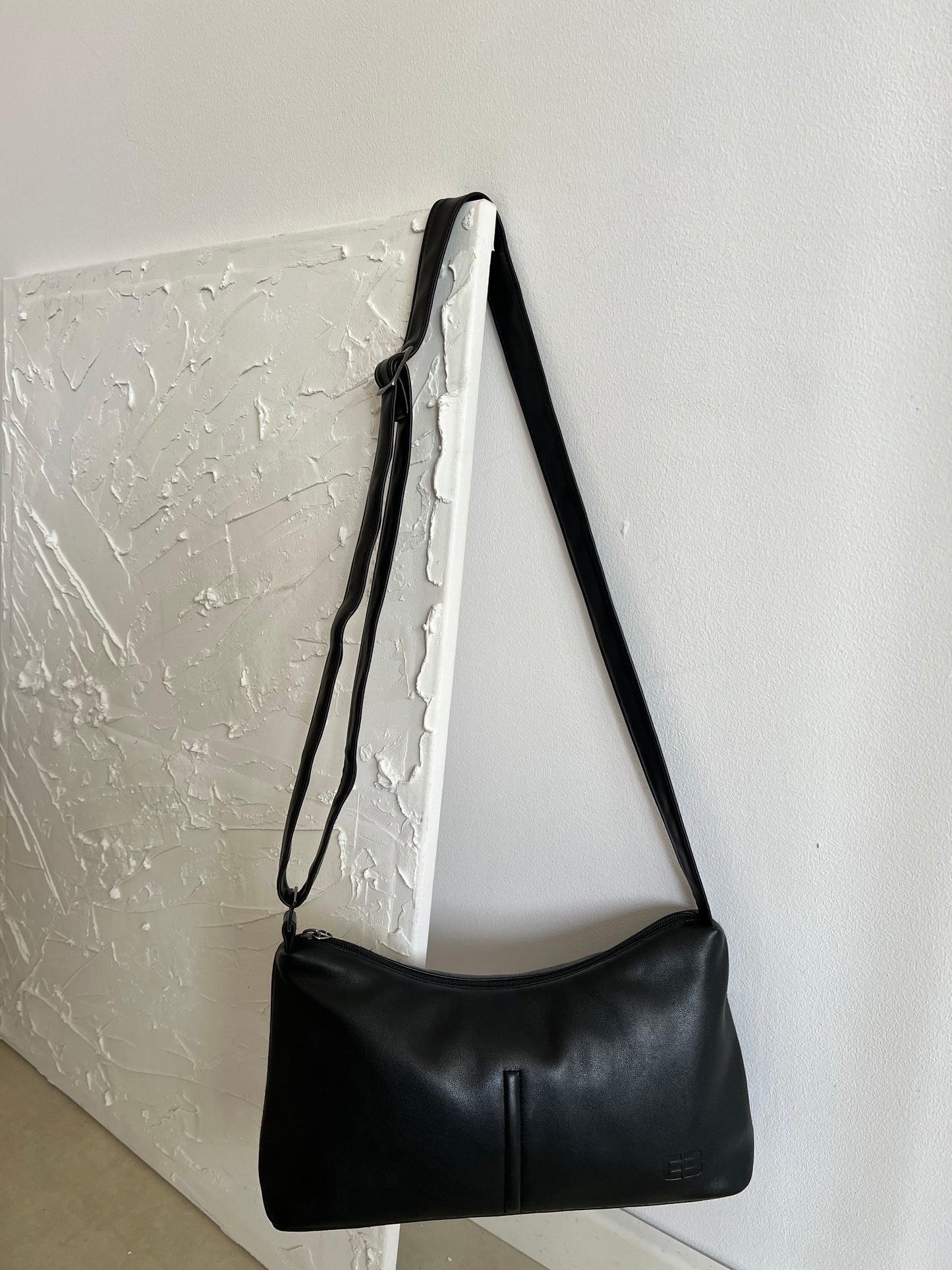 Black bag with a long strap